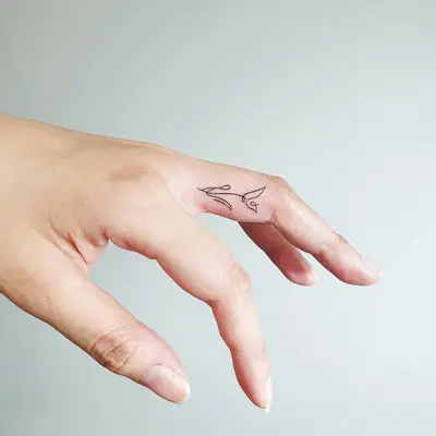 Finger with flower tattoo
