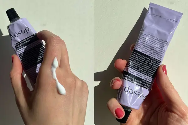 two hands holding tubes of the Aesop Resurrection Aromatique Hand Balm with one hand having the hand balm on it