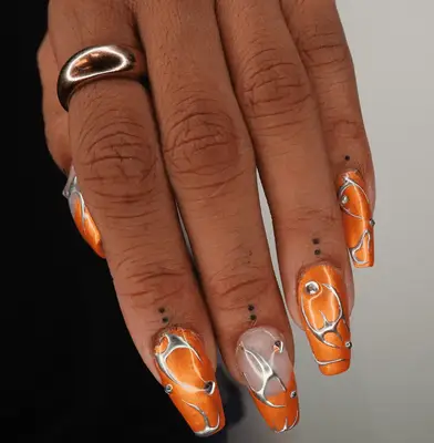 Close up of Hailey Bieber with her hand, covered in small tattoos, on her mouth