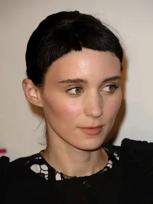 Close-up of Rooney Mara with a short bangs hairstyle and an eyebrow piercing