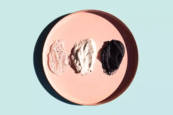 Scrub or beauty facial masks smears on pastel pink plate