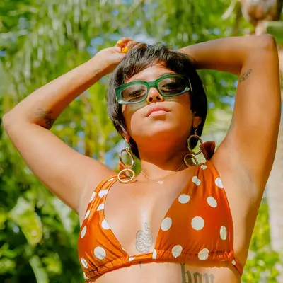 person in sun with tattoos