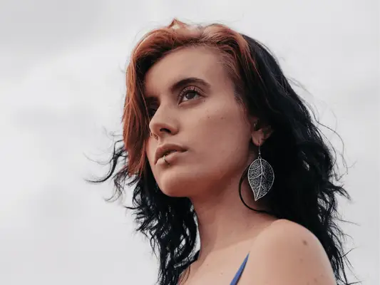 A woman with a nose and lip piercing