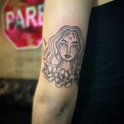 Image of a Virgo maiden tattoo on the back of someone
