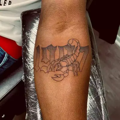 Image of a Scorpio scorpion tattoo with numbers in the back