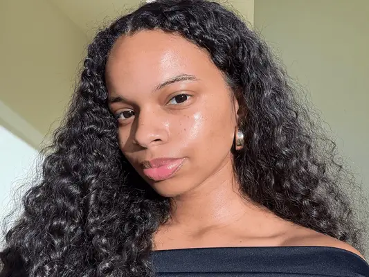 MYM Beauty senior beauty editor Olivia Hancock with glowing, dewy skin