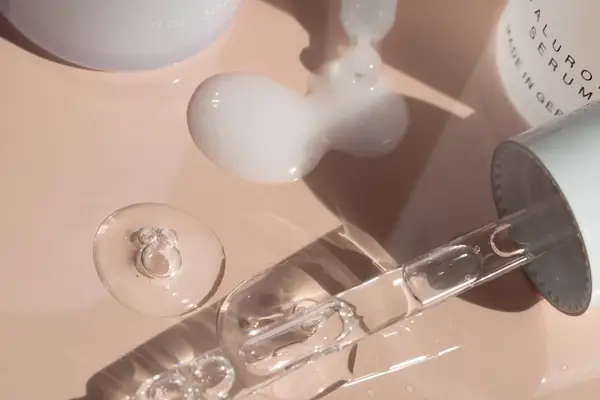 Serums on a pink background.