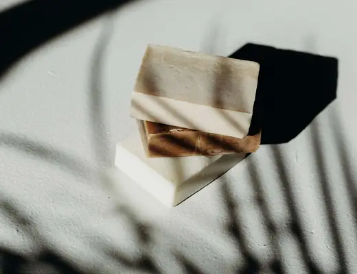 bars of soap stacked on shadowy background