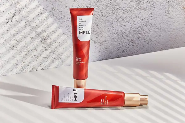 Tubes of Mele Plump It Up Nourishing Facial Cream displayed on a white counter
