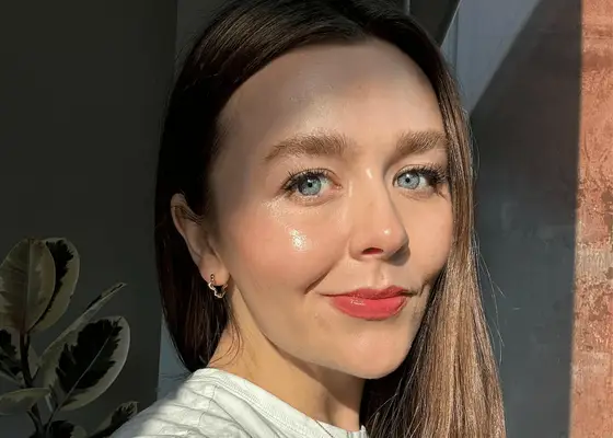 woman with dewy skin looking into camera