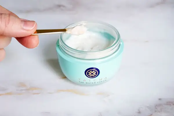 Person applies Dr. Barbara Sturm Face Cream Rich to their hand