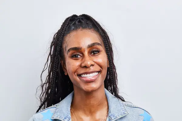 Woman smiling as she tests Shani Darden Hydration Peptide Cream