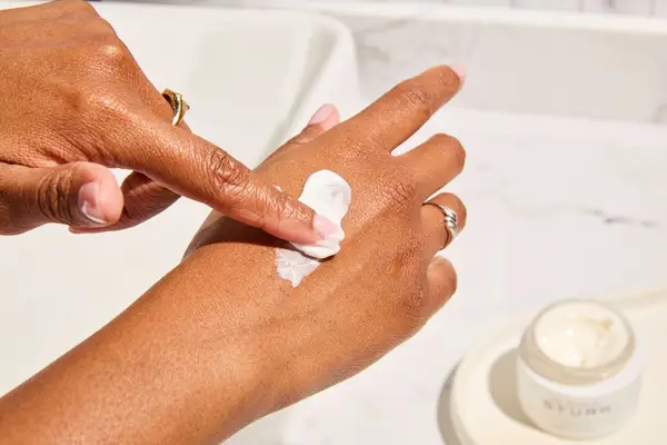 Person applies Dr. Barbara Sturm Face Cream Rich to their hand