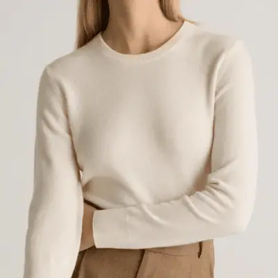 Photo of person wearing an ivory crewneck cashmere sweater 