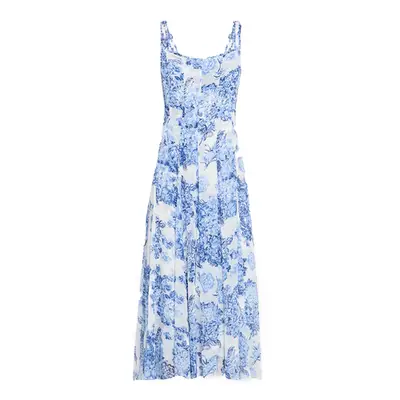 Olivia Rodrigo wears a patterned maxi dress with polka dotted scarf