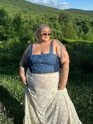 Abby Bible wearing a denim tank top and lace skirt