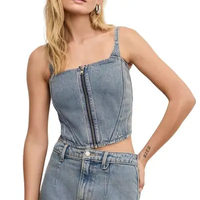 Model wearing a light wash denim top