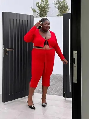 Abisola Omole wearing a matching red cropped sweater and capris