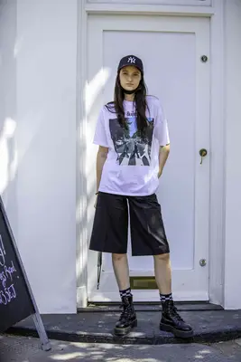 A person wearing Dr. Martens with jorts. 