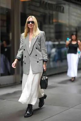 A person wears a dress and Dr. Martens.