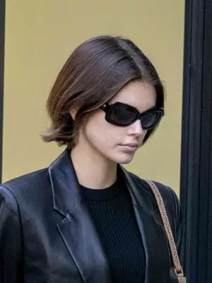 Kaia Gerber wearing black sporty sunglasses