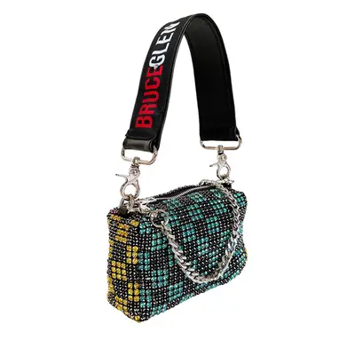 Longchamp Le Pliage travel nylon tote bag in green on gingham pillow next to basket by water