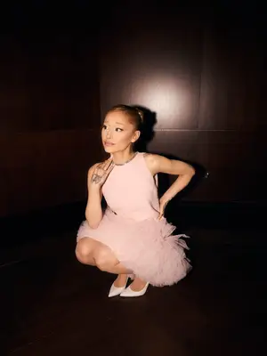 Ariana Grande wears a millennial pink dress and pumps