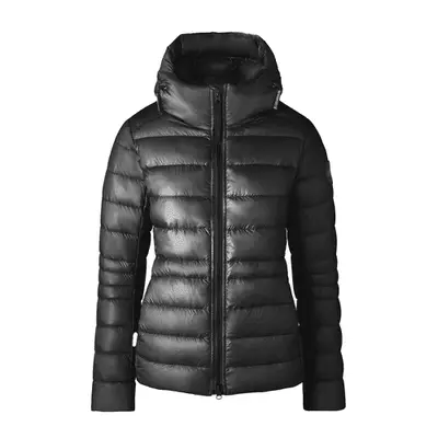 A model is holding a book wearing a gray wool turtleneck