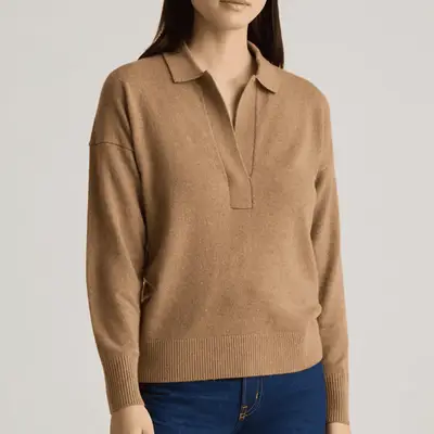 Woman wearing turtleneck sweater, trench coat, and Louis Vuitton shoulder bag