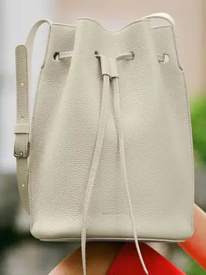 Close-up of Mansur Gavriel Champagne Bucket Bag in pearl white leather