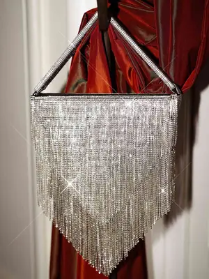 Sparkly handbag hanging on hook with drape of red fabric