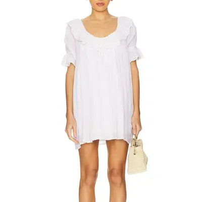 model wearing a short white dress