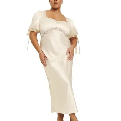 model wearing a cream Reformation dress