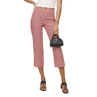 model wearing red gingham capris and carrying small black Miu Miu handbag