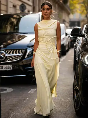 Woman wearing high-neck cream sleeveless maxi dress and silver bangles - MYM Beauty Summer Dress Trends