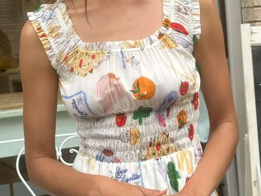 Close-up of woman wearing pasta and tomato-patterned dress