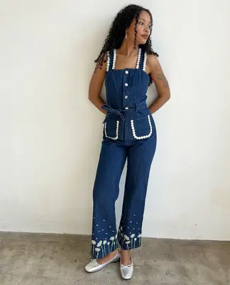 Model wearing silver shoes with a denim outfit