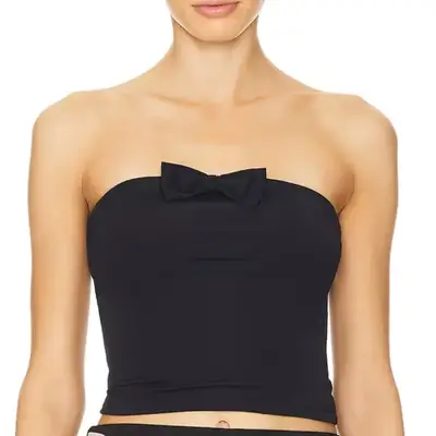 model wearing a tube top with a small bow