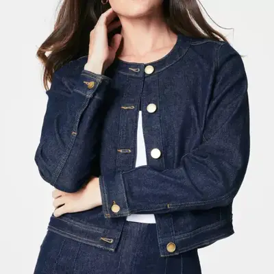 model wearing a dark wash jacket with gold buttons