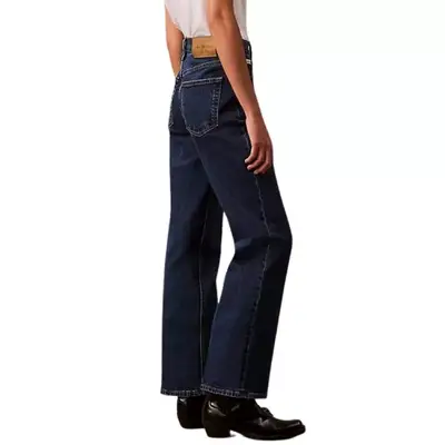 person wearing dark wash boot-cut jeans