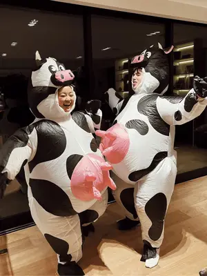 Lana Condor and husband Anthony De La Torre wearing inflatable cow costumes.