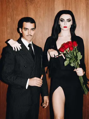 Joe Jonas and Sophie Turner dress as Morticia and Gomez Addams.