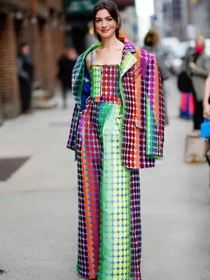 Anne Hathaway wearing vibrantly colored polka-dot pantsuit