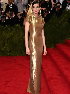 Anne Hathaway in a hooded gold Ralph Lauren gown at the 2015 Met Gala
