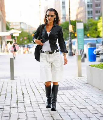 Bella Hadid wearing long shorts and boots