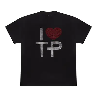 Olivia Rodrigo wears an Angelina Jolie graphic tee, white tennis skirt, black sunglasses, and silver jewelry