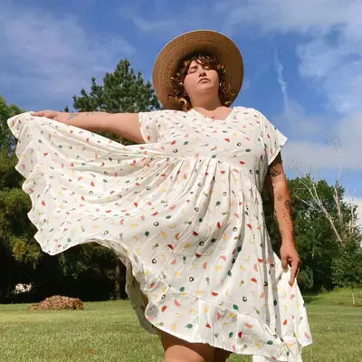 A woman wears a tank top and underwear