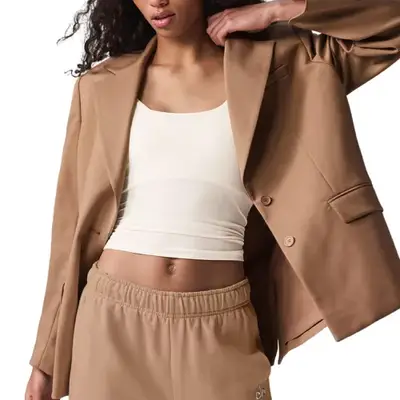 Model wearing a light tan blazer