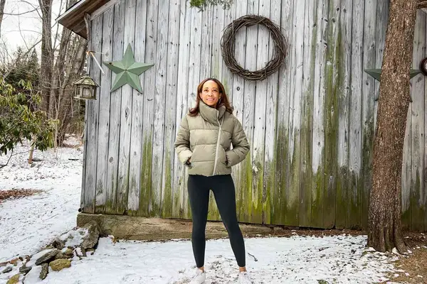Three photos of a model wearing the Girlfriend Collective Compressive High-Rise Legging, the OFFLINE By Aerie OG Legging, and the SPANXshape™ Booty Boost 7/8 Leggings while standing outside in the snow