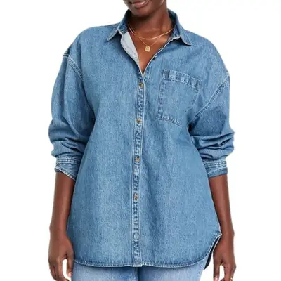 model wearing a mid-wash denim button-down blouse